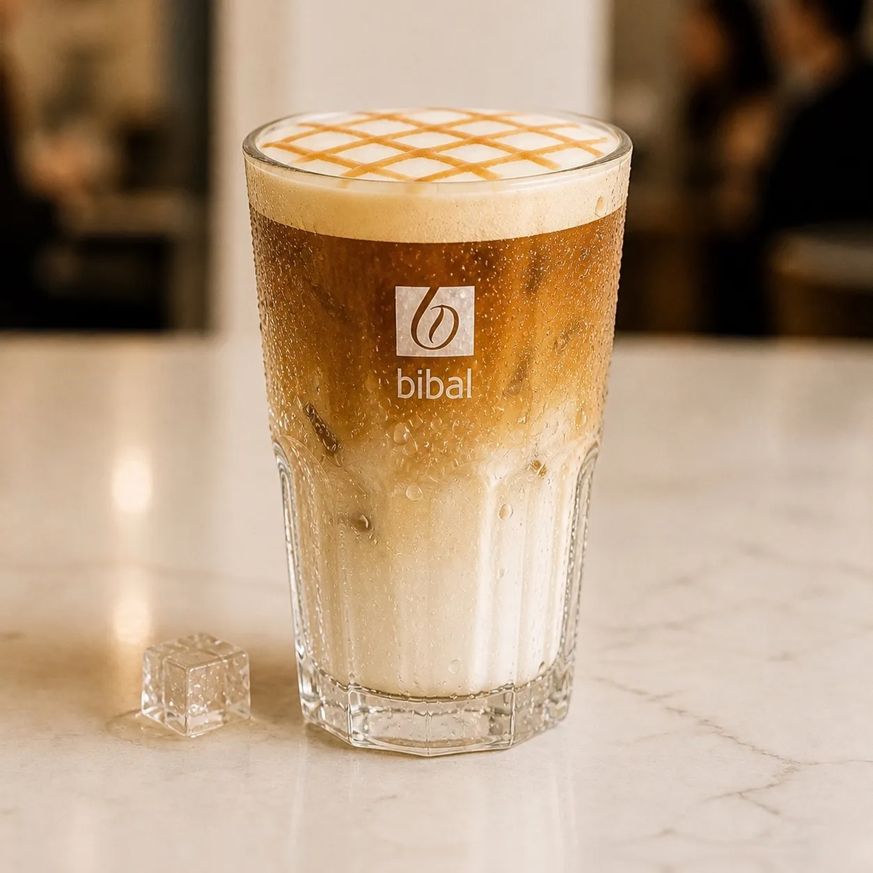 Iced Caramel Macchiato — la même boisson en gros plan à 45° : la matière, la texture et le service