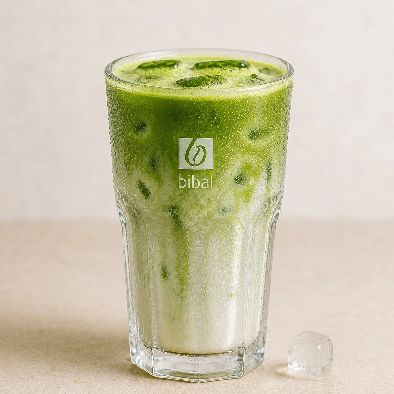 Iced Matcha Latte Kusmi — la même boisson en gros plan à 45° : la matière, la texture et le service